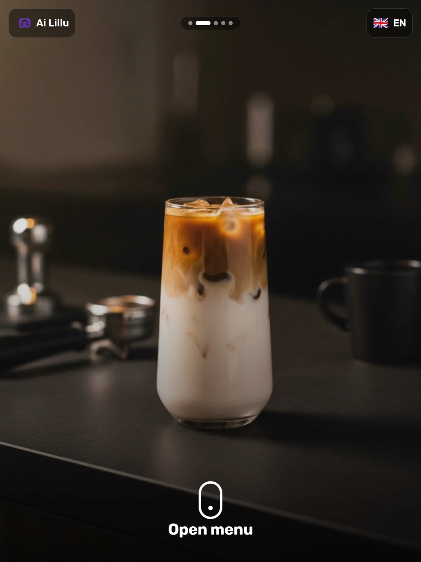 The kiosk idle screen: a full-bleed video still of an iced coffee on a bar counter, the venue chip and a language switch along the top, slide dots, and an Open menu prompt at the bottom.